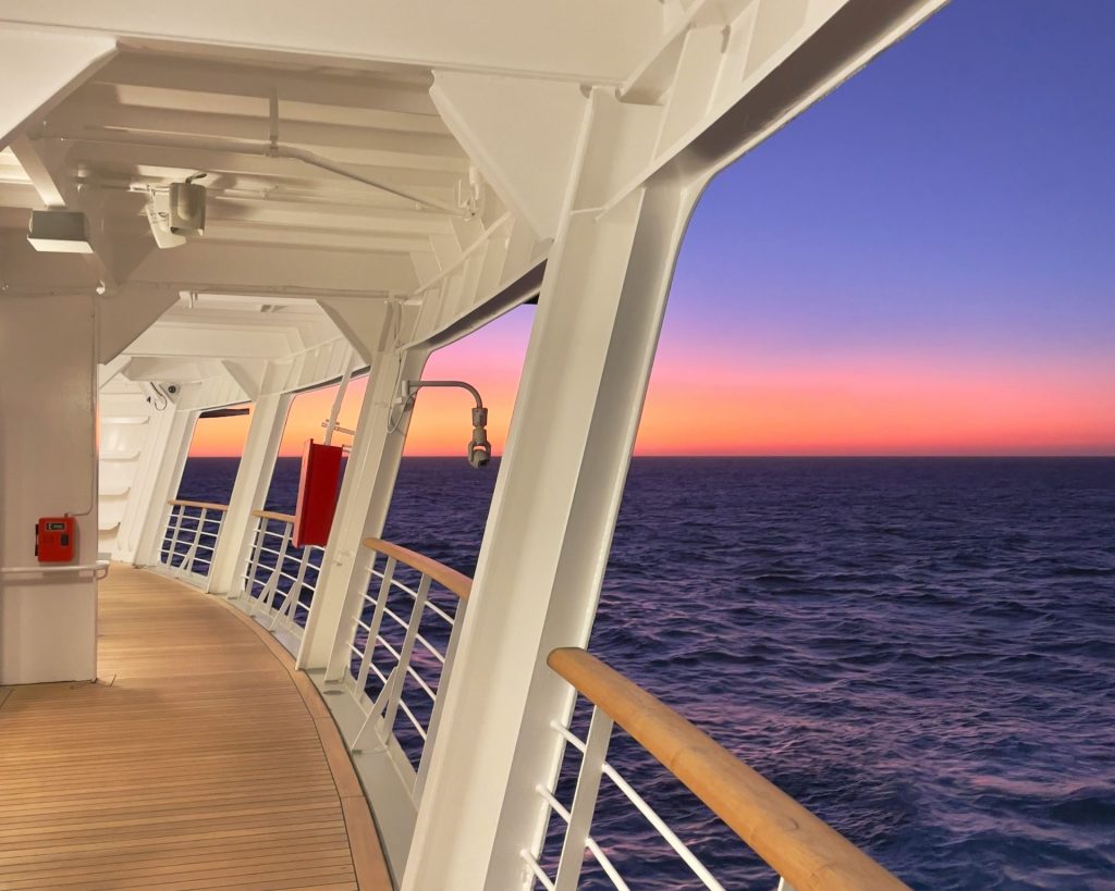 the deck of a cruise ship at sunset